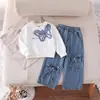 Conjunto de Dos Piezas para Niña Otoño 2026 Transfronterizo: Top Redondo con Estampado de Moños y Pantalones de Mezclilla Lavada con Moño Tridimensional