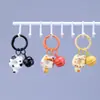 Clip de resorte Campanita Llavero de Gato Dibujo animado lindo Gato Donut Mochila Funda para auriculares Colgante de moda versátil