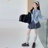 Conjunto de 3 Peças Feminino Outono Nova Chegada Estilo College Camisa Listrada com Gravata Colete de Couro Saia Plissada Saia Curta Tendência