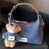 Bolso de mezclilla exquisito y moderno de nicho para mujer, nuevo bolso cruzado versátil de moda 2025, bolso de mano pequeño para salidas