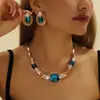 Collar y Pendientes de Aleación de Zinc Dorado con Incrustaciones de Pedrería y Cristal Azul, Set de Joyería para Mujer de Venta Caliente Europea y Americana, Hecho a Medida