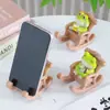 Creativo Lindo Relleno de Escritorio de Oficina Rana Soporte para Teléfono Móvil Artesanía de Resina Adornos Decorativos Regalo de Cumpleaños