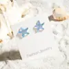 Aretes Europeos y Americanos Transfronterizos Frescos y Dulces Viento de Playa Estrella de Mar Concha Acrílico Viento Vacacional Pendientes con Colgante de Caracola