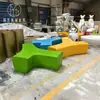 Taburete de plástico reforzado con fibra de vidrio rama de árbol creativa hermosa combinación de letras Chen costura asiento centro comercial área de asientos al aire libre en el parque asiento