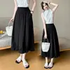 Nueva falda casual de diseño otoñal para mujer con cintura elástica, bolsillos y un dobladillo tipo tulipán de longitud media.