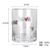 El fabricante personaliza parches metálicos 3D con elementos navideños y diseños florales para vasos de agua de cristal y vasos de jugo, basándose en los dibujos y muestras proporcionados.