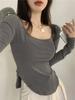 Otoño 2025 Nuevo Cuello U Color Sólido Sexy Escote Bajo Irregular Ajustado Manga Larga Camiseta Top de Capa Interior para Mujer
