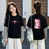 Camiseta de manga larga tipo dos piezas de imitación para niños, colección otoño 2026, para niñas, 100% algodón, cuello redondo, corte holgado, diseño lindo de caricatura, top básico