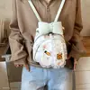 Mochila de mano, bolso de un solo hombro, diseño de caricatura lindo, estilo de mujer, 2026, moderno, color crema, otoño, simple, con un moño, estilo nuevo