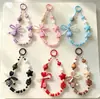 Cadena para teléfono con cara sonriente de dopamina en forma de corazón, pulsera de cuentas con lazo, cadena de muñeca Xiaohongshu, amuleto para bolso, cámara y botella de agua
