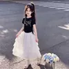 2026 Camiseta de Manga Curta com Cordão e Laço Doce Estilo Princesa Saia de Renda Bolo Conjunto de Duas Peças de Verão para Meninas