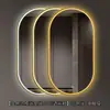 Espejo de baño inteligente ovalado en stock con lijado exterior e iluminación LED translúcida, adecuado para montaje en pared de baño y proyectos hoteleros, con opciones de personalización.