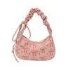 Bolsa de brazo impresa de alta calidad para mujer, un nuevo estilo transfronterizo con un diseño de lazo fresco y delicado, un bolso de hombro chic y elegante, y un bolso de mano único
