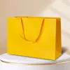 Bolsa de Papel para Fabricantes al por Mayor Spot Bolsas de Papel para Regalo Ropa Bolsa de Papel para Oficina Corporativa Bolsa de Mensajero Bolsa de Compras Logo Impreso