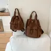 Mochila casual lisa de estilo minimalista 2026, con un diseño único, perfecta para estudiantes universitarios para usar al ir de compras o salir.