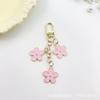 Llavero con forma de flor de gota de aceite de color transfronterizo de Europa y Estados Unidos, personalidad creativa, lindo bolso colgante con juego de auriculares