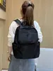 Mochila de tela de nailon ligera y duradera de color sólido con un tacto de alta gama, adecuada tanto para hombres como para mujeres, multibolsillos, mochila de gran capacidad para negocios y viajes.