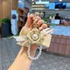Estilo Coreano Nuevo Llavero de Coche con Lazo Bordado de Encaje Decoración Colgante de Bolsa de Cuentas Creativa Camelia Moda