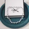 Venta Caliente Europea y Americana Lujo Ligero Alto Sentido del Diseño Perla de Imitación Hecho a Mano con Cuentas Lazo Collar Pulsera Conjunto de Dos Piezas