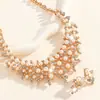 Accesorios de conjunto de collar y pendientes de aleación hueca de perlas artificiales de moda transfronterizos, accesorios de joyería para bodas de mujer