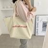 Bolsa de Ombro Estilo Coreano 2022 Primavera e Verão Grande Capacidade Estampa de Letras Formato Balde Lona Estudante Simples para Viagem Bolsa de Tecido