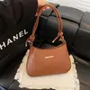 Bolsa vintage de axila com textura nicho para mulheres, nova tendência 2026 moda versátil simples de ombro transversal sela