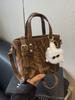 Bolso pequeño popular de este año para mujer 2025 primavera nueva moda bolso bandolera de hombro tendencia de textura bolso de cubo portátil