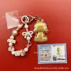 Llavero de tela con logo de empresa personalizado Cadena para teléfono móvil Angela Lámina de oro puro Oro 999 Regalo de aniversario