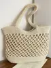Bolsa de playa portátil de gran capacidad para mujer, nuevo diseño de primavera 2026, bolsa tejida hueca, bolso casual versátil para hombro y axila