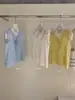 Wgwe9043 Ropa de Mujer Shisanxing de Guangzhou 2026 Nuevo Diseño sin Mangas con Adorno de Encaje Chaleco Camisa Top Verano