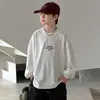 Camiseta de manga larga de otoño para niño, nuevo modelo primavera y otoño 2026, base blanca, prenda interior grande para niños, top de algodón puro, moderno
