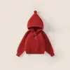 Suéter amarillo con capucha de nuevo estilo 2026 para niñas, tejido de punto con pompón para niños de otoño e invierno, top moderno y grueso para bebés