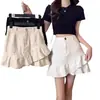Falda corta de mezclilla blanca irregular con dobladillo de volantes para mujer, cintura alta, línea A, bodycon de verano, adelgazante 2026
