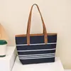 Bolso tote tipo cubo a rayas de alta gama para mujer, nuevo, elegante, versátil, de un solo hombro, cruzado, para llevar debajo del brazo