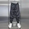 Nuevos pantalones deportivos casuales de otoño e invierno para hombre, de corte holgado, modernos, elegantes, sencillos, versátiles y adecuados para estudiantes, con un diseño de pierna cónica
