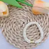 Anel de intestino pequeno pequeno de alta elasticidade na cor creme pode ser acessórios pegajosos DIY faixa de cabelo faixa de cabelo corda de cabelo versátil acessórios de cabelo
