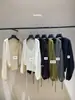 Su nueva colección de otoño presenta un conjunto de dos piezas de cárdigan de punto con cordones y top de tirantes, simple y elegante 66909