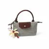 Mini bolso de mano tejido con paja transfronterizo tipo dumpling, bolso de mano retro con tapa abatible, nuevo estilo 2026 bolso tejido para mujer, personalizable para vacaciones