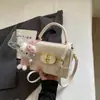Bolso pequeño rosa a cuadros súper popular para mujer, nuevo bolso cruzado versátil de moda 2026, bolso cuadrado pequeño informal tipo caja estilo coreano