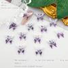 Explosiones transfronterizas bolsa de material para joyería de uña negra accesorios de resina luminosa mariposa de destello fino púrpura joyería al por mayor