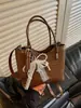 Bolso tejido de nicho de alta gama nuevo para primavera y verano, bolso cubo, bolso tipo empanada, bolso de axila simple y elegante de alta gama para mujer