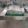 Máquina envasadora al vacío de laminación continua personalizada de fábrica, equipo de envasado para mantener la frescura de las patas de pollo y maíz, máquina selladora de salsas y encurtidos.