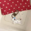 Nuevo llavero acrílico beige de tamaño pequeño para perros y gatos, colgante para bolsa, accesorio de regalo, decoración al por mayor