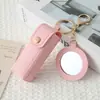 Mini llavero de lipstick portátil, bolsa redonda de cuero con espejo de maquillaje, accesorio para niñas, colgante de bolsa de espejo de maquillaje portátil