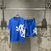 Marca de moda estilo americano SYNA WORLD Traje de manga corta estilo taladro High Street Hip Hop Ins Verano Pantalones cortos casuales para hombres y mujeres