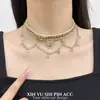 Collar de felpa de mariposa de doble capa vintage con un estilo étnico de lujo ligero de alta gama, cadena de clavícula en capas Maillard de moda