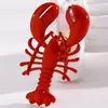 Broche de aleación estilo vacacional transfronterizo europeo y americano en la playa y el océano, personalizado con goteo de aceite de langosta y cangrejo rojos