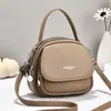 Bolso de mano nuevo para mujer transfronterizo, bolso redondo pequeño simple y elegante, bolso de hombro y bandolera, bolso versátil para mujer viajera al por mayor