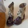 Estilo retro diseño de nicho sentido de la moda otoño e invierno botas western mujer 2026 nuevo modelo botas cortas de lona con lazo botas de jinete