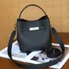 Bolso tipo cubo de piel de vaca de capa superior estilo cesta para mujer, piel genuina, nuevo modelo 2026, bolso de hombro versátil de alta gama, bolso de mano, bolso cruzado para mujer